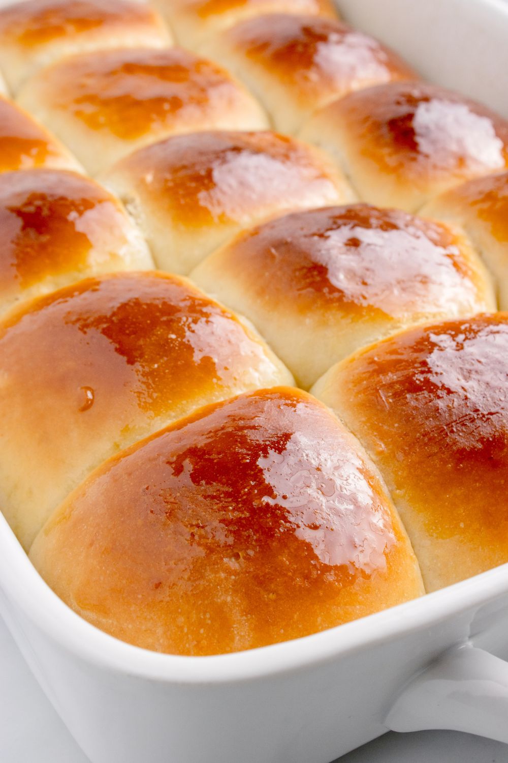 buttered Hawaiian rolls in a pan 