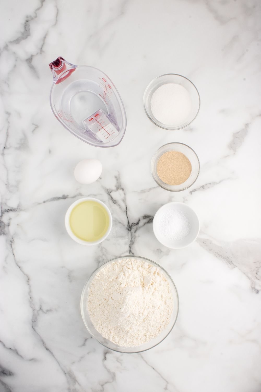 all the ingredients to make Pull Apart Dinner Rolls in single serve containers sitting on counter 