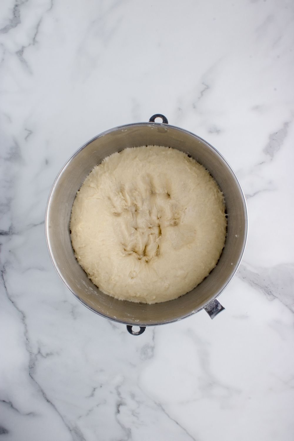 bread dough risen in a bowl on table for making Hawaiian rolls