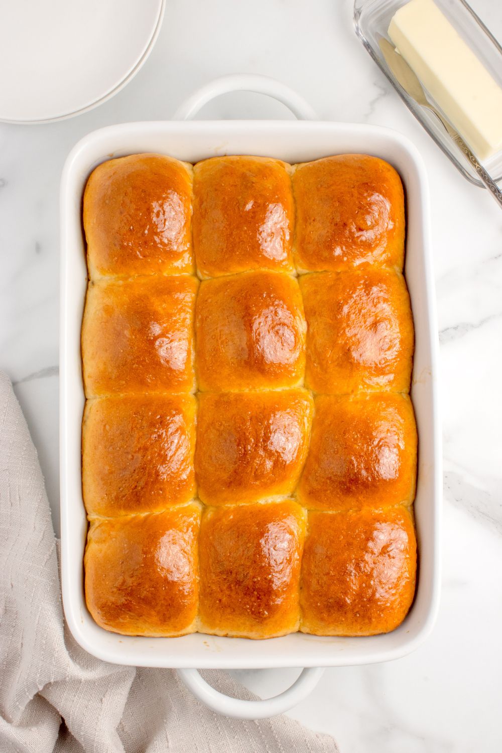 buttery baked pull apart rolls in casserole pan on table