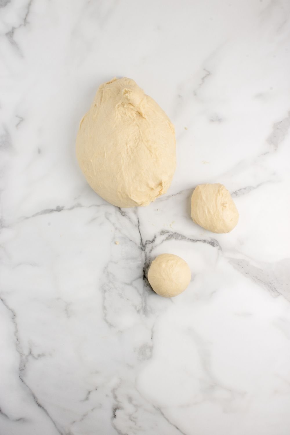 pull apart roll dough on counter rolled into balls 