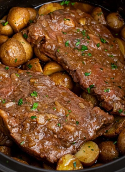 Crock Pot Steak and Potatoes in a black crock pot on table