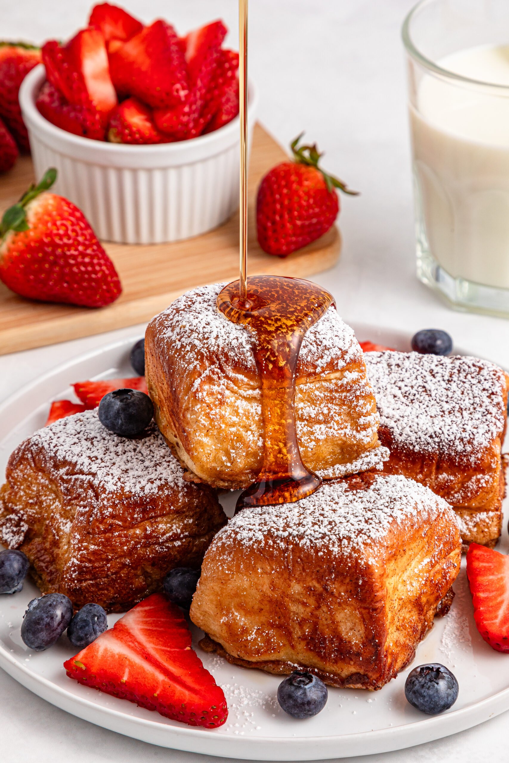 syrup being poured on top of the Hawaiian Roll French Toast