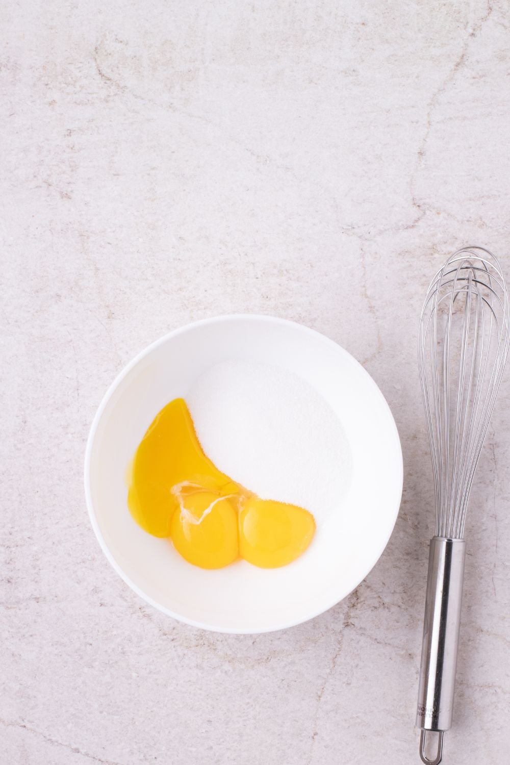 egg and milk mixture in a bowl with whisk by it