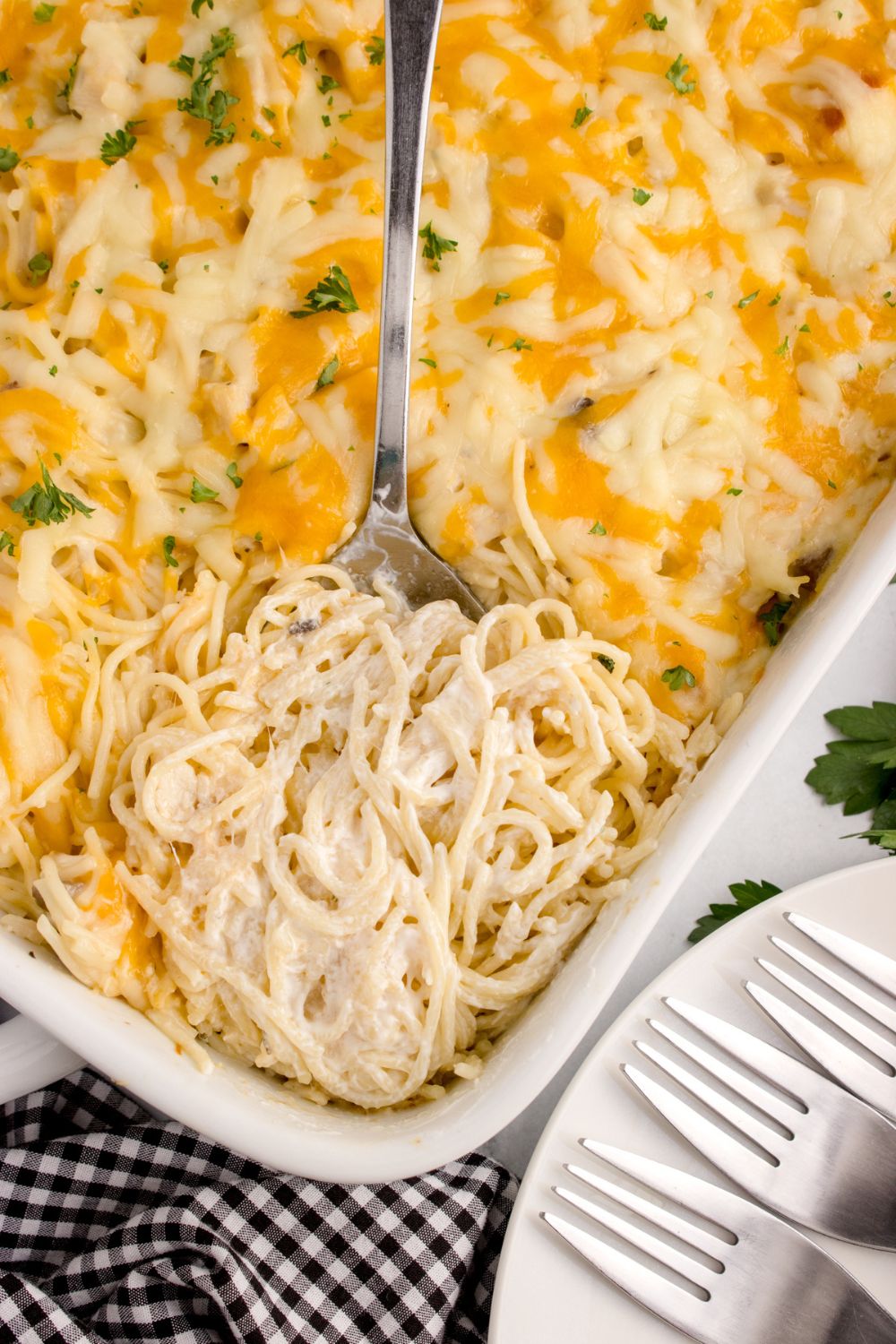 overhead look of chicken tetrazini in a pan with a spoon scooping some up