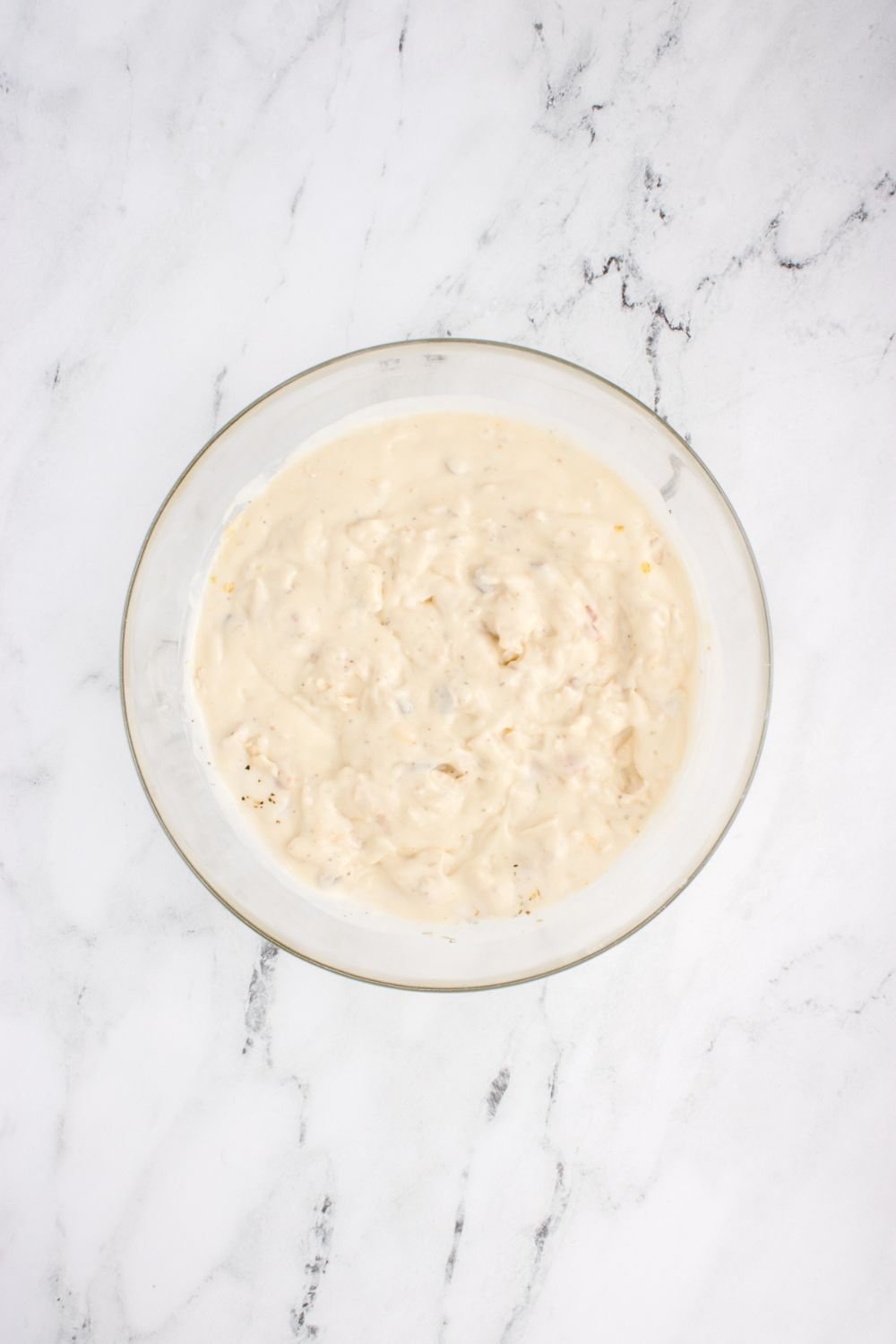 cream sauce mixed up in bowl on table for chicken tetrazzini