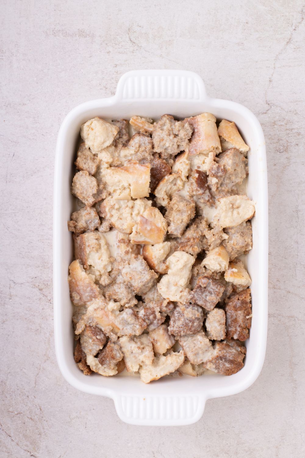 raw Banana Bread Pudding in casserole dish on table 