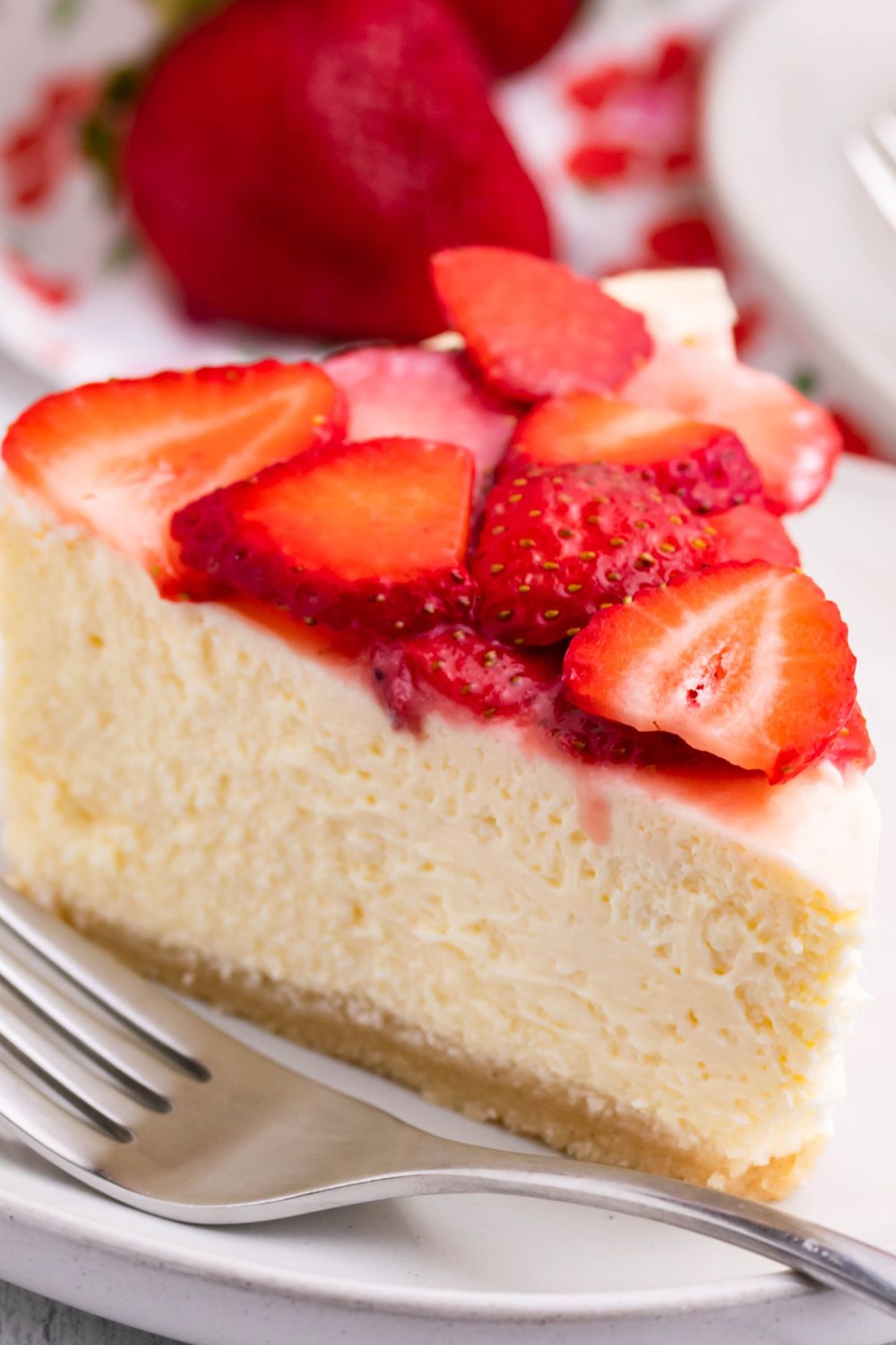Keto Cheesecake on a plate topped with fresh strawberries 