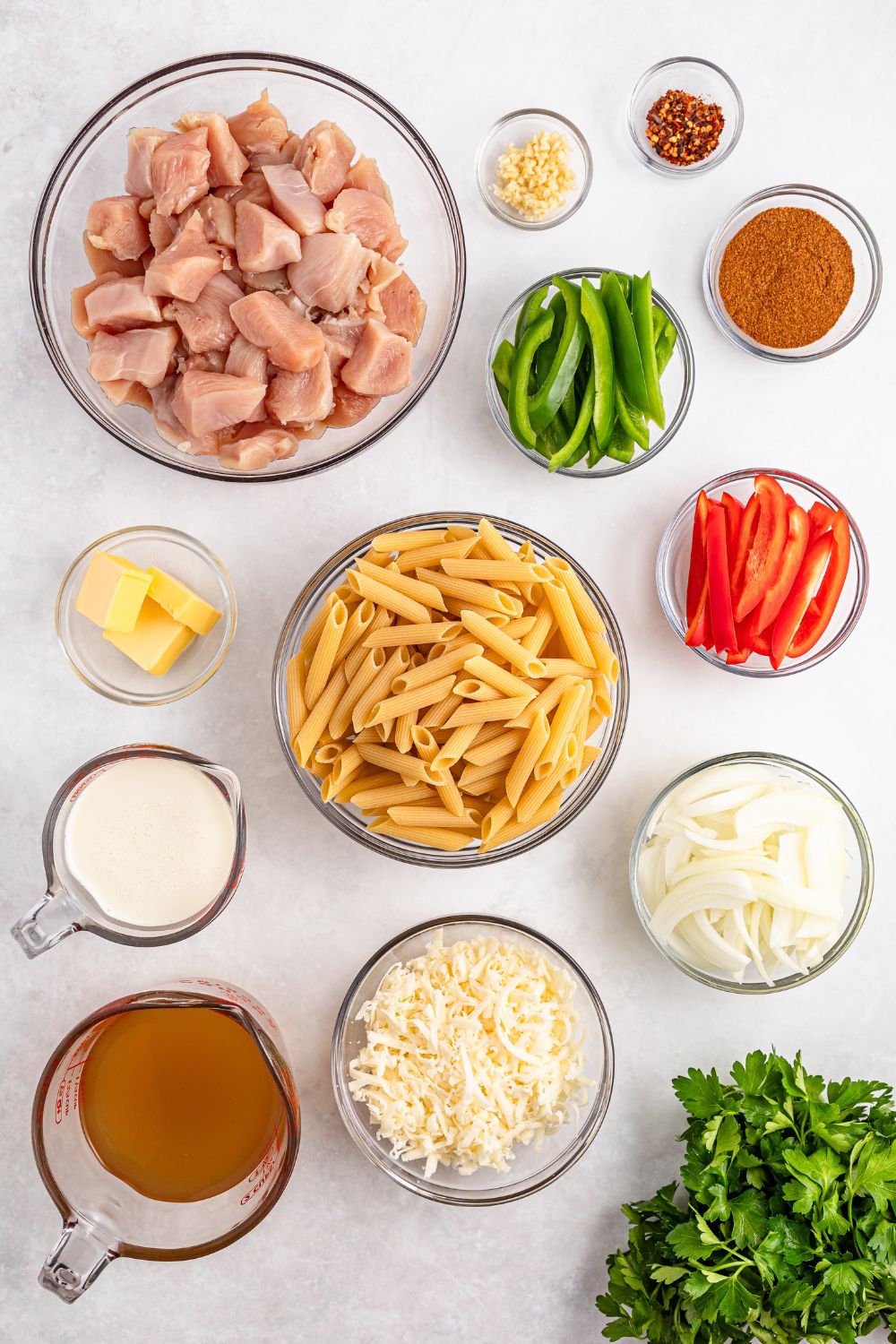 ingredients for Rasta Pasta in single serve bowls on white counter 