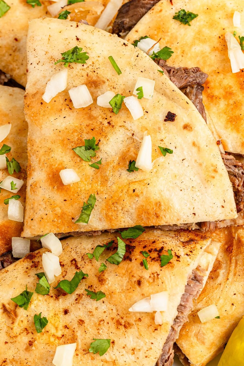 Mississippi Pot Roast Quesadillas stacked on top of one another 