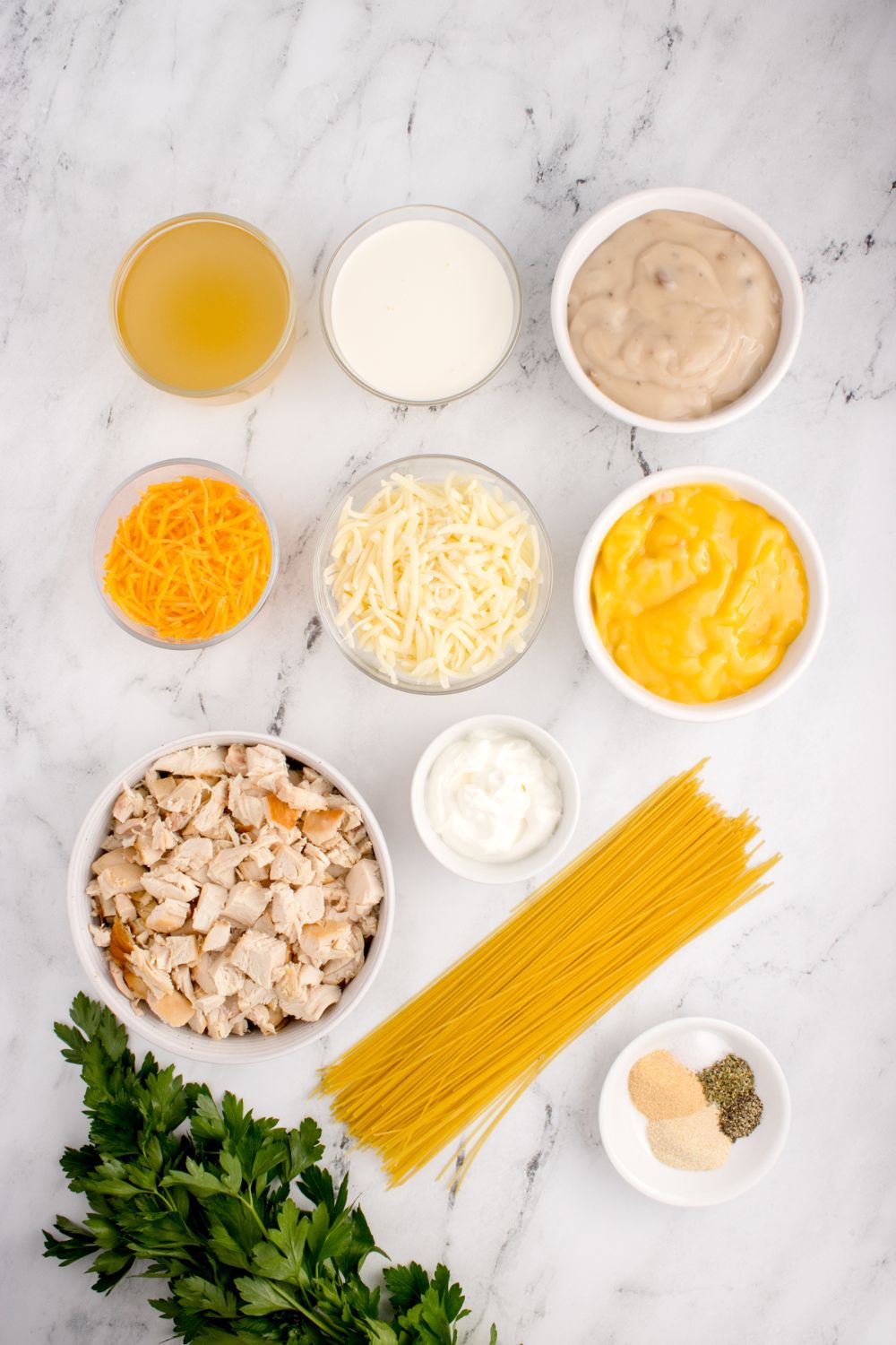 ingredients for chicken tetrazzini in single serve bowls on table 