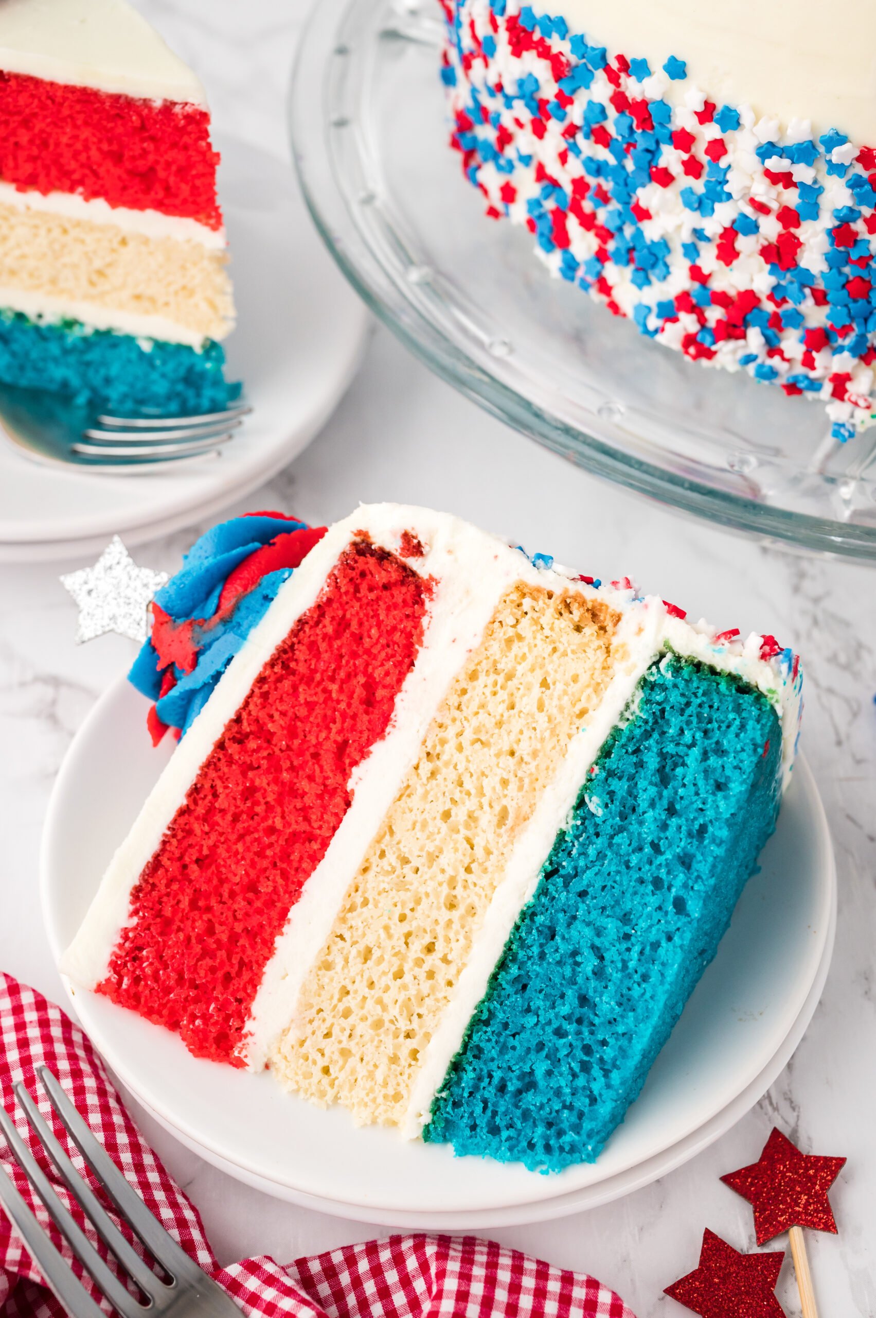 overhead shot of a Slice of American Flag Layered Cake on a white plate 