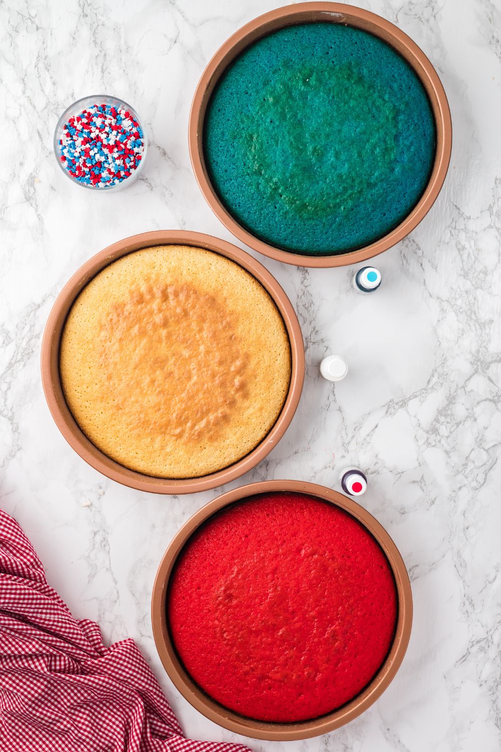 round cakes that are red, white, and blue sitting on table in pans 