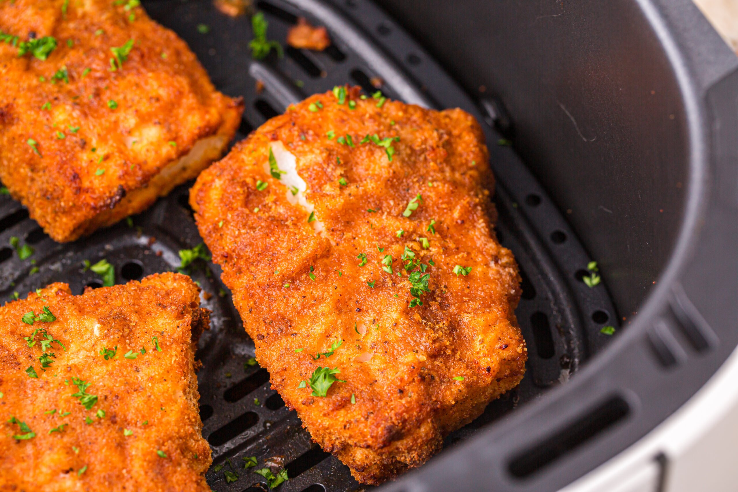 Up close shot of the Air Fryer Fish inside the air fryer basket