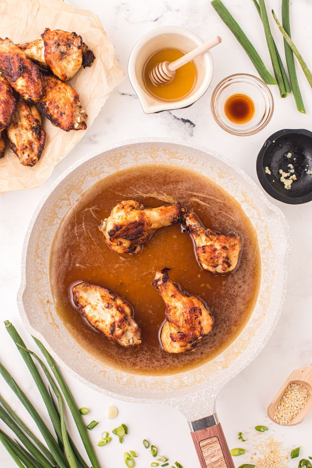 honey garlic wings coating in sauce 