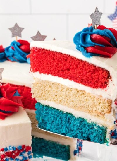American Flag Layered Cake with a slice being lifted out with spatula
