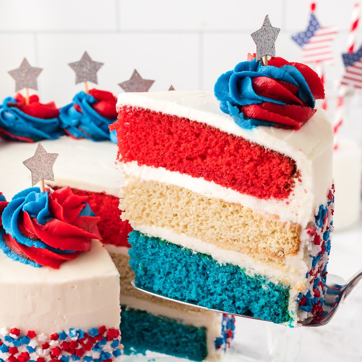 American Flag Cake with a slice being lifted out with spatula