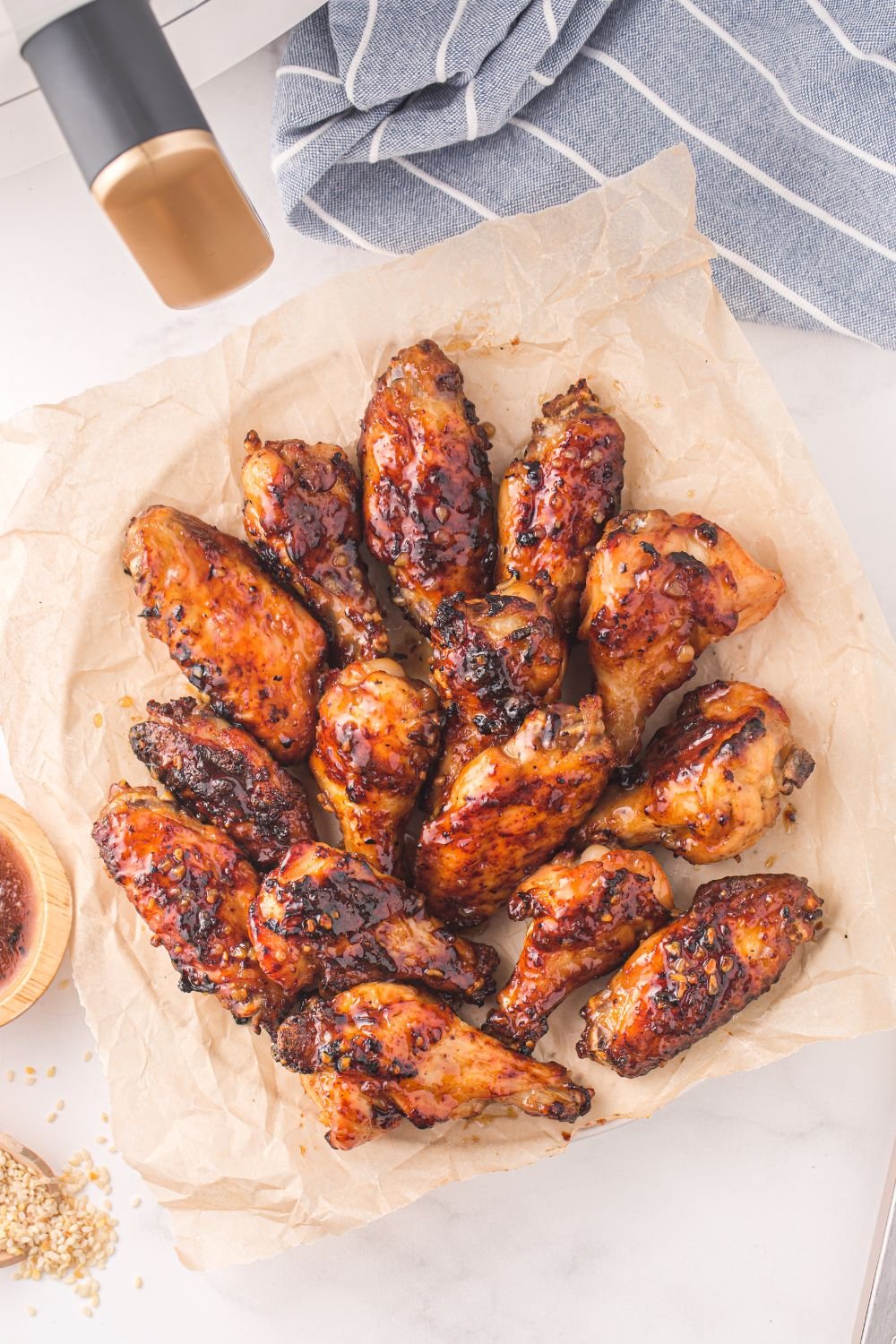 Air Fryer Honey Chicken Wings on a parchment lined plate 