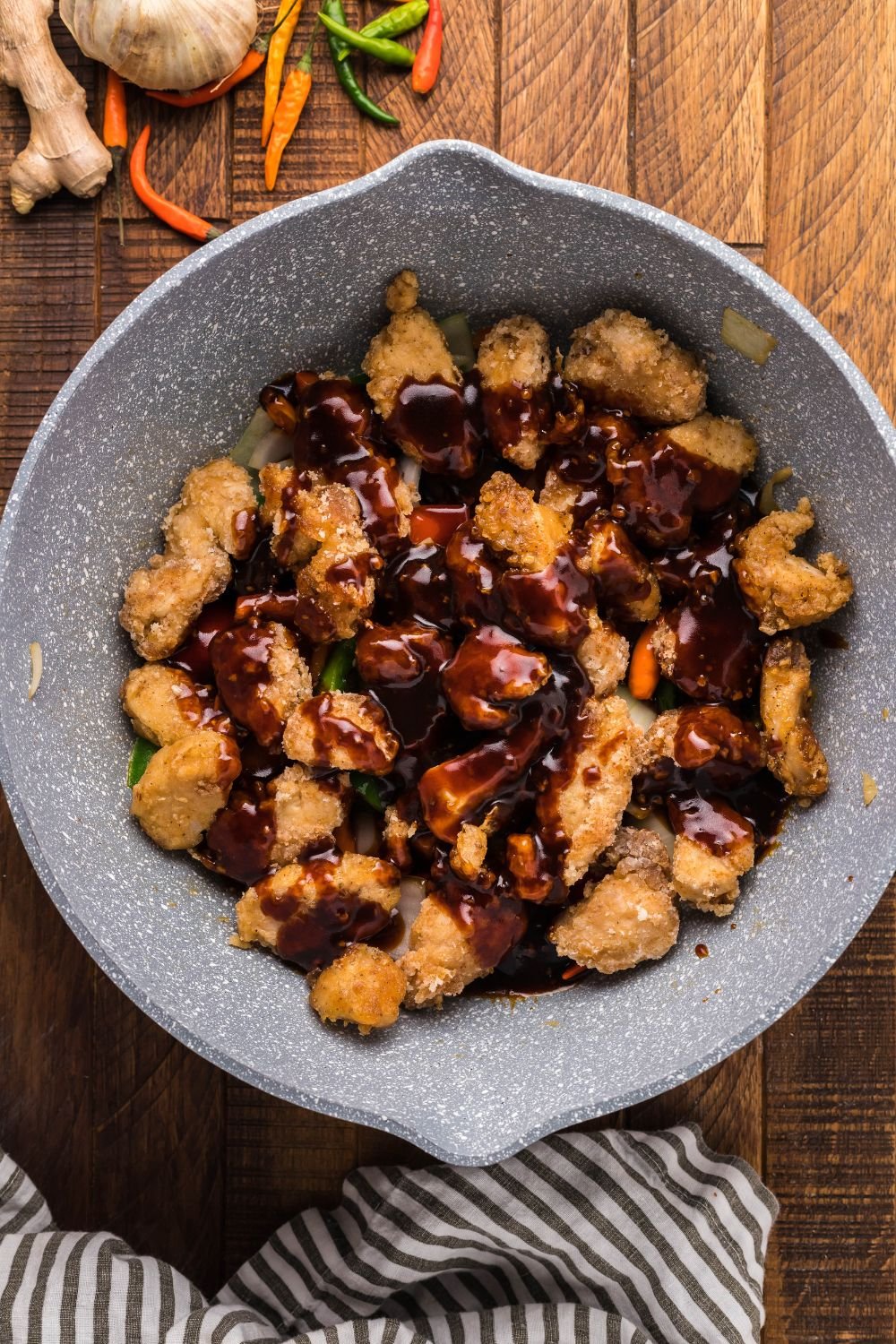 cooked chicken and sauce being drizzled over cooked chicken 