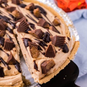 Reeses No Bake Pie in a baking dish with a slice being lifted out