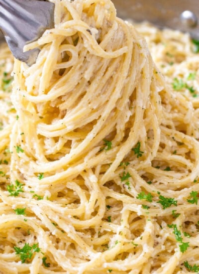 Creamy Garlic Pasta being lifted up in a silver pan