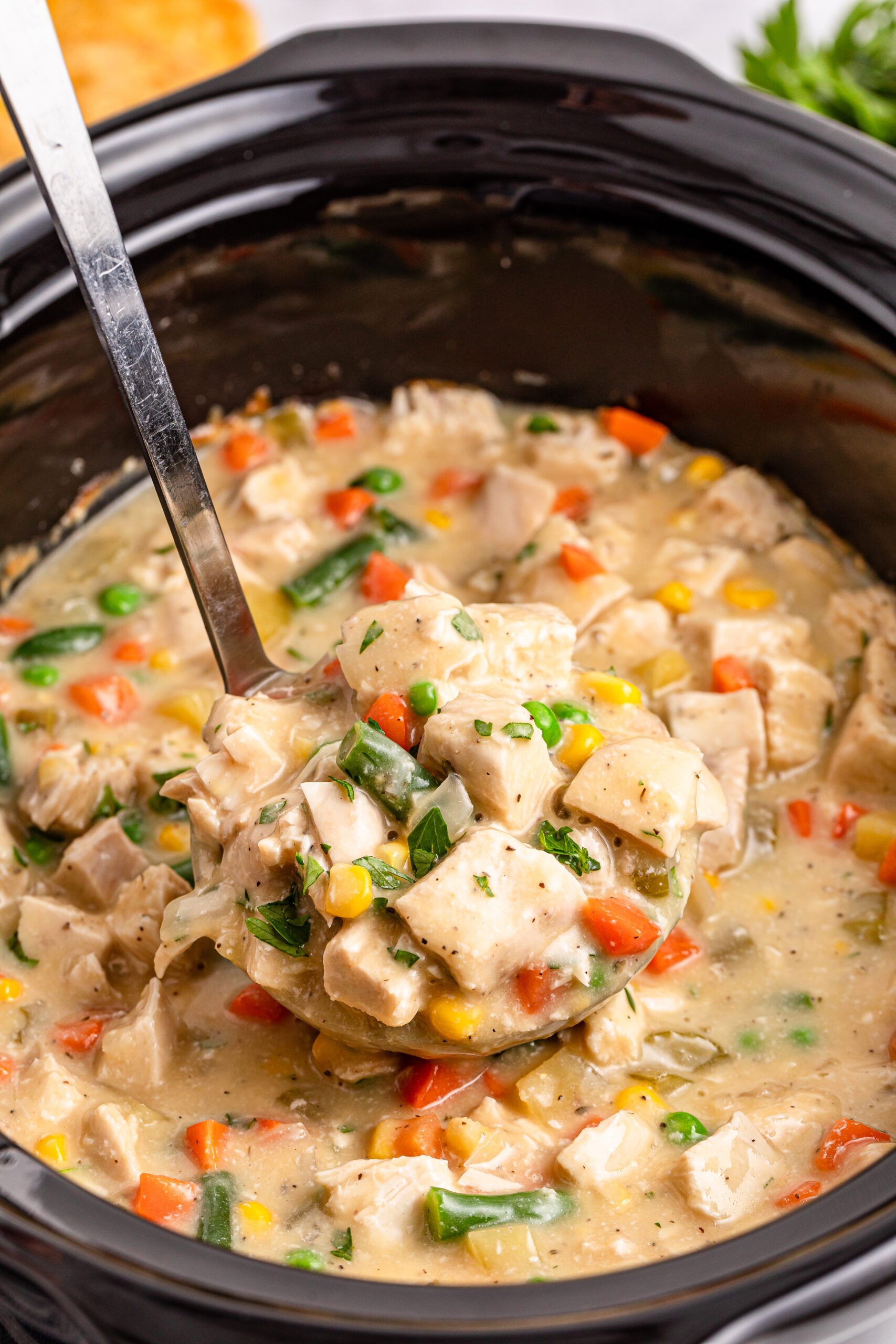 overhead shot of the Slow Cooker Chicken Pot Pie in a black crock pot 