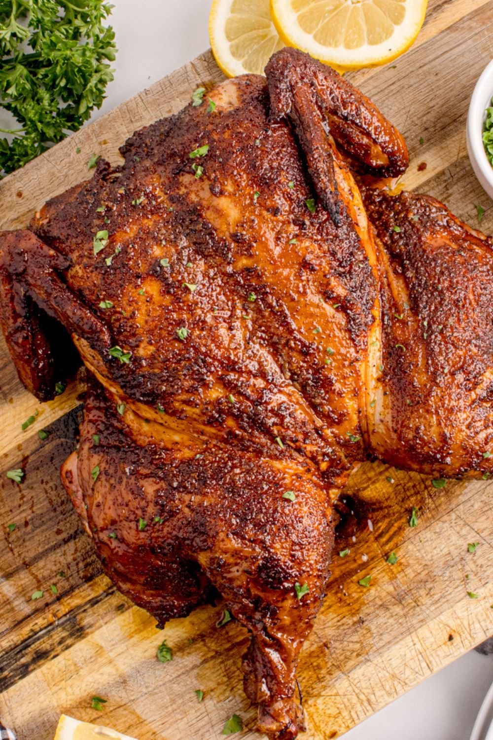 Smoked Whole Chicken on a wooden cutting board 