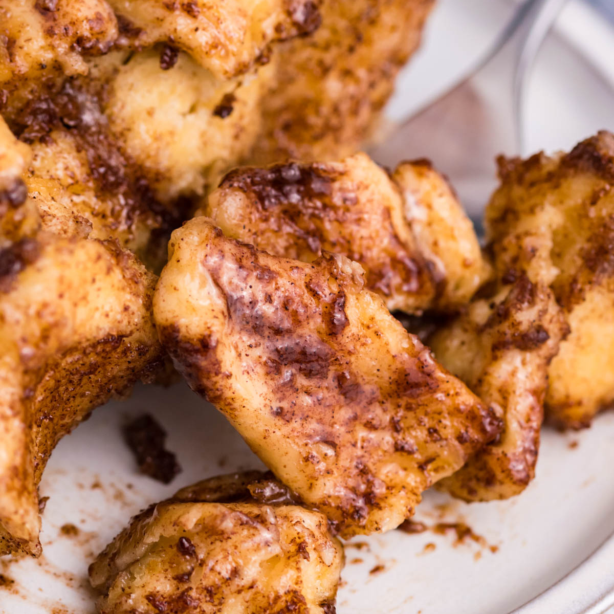 Up close view of the cinnamon sugar on the casserole on a white plate