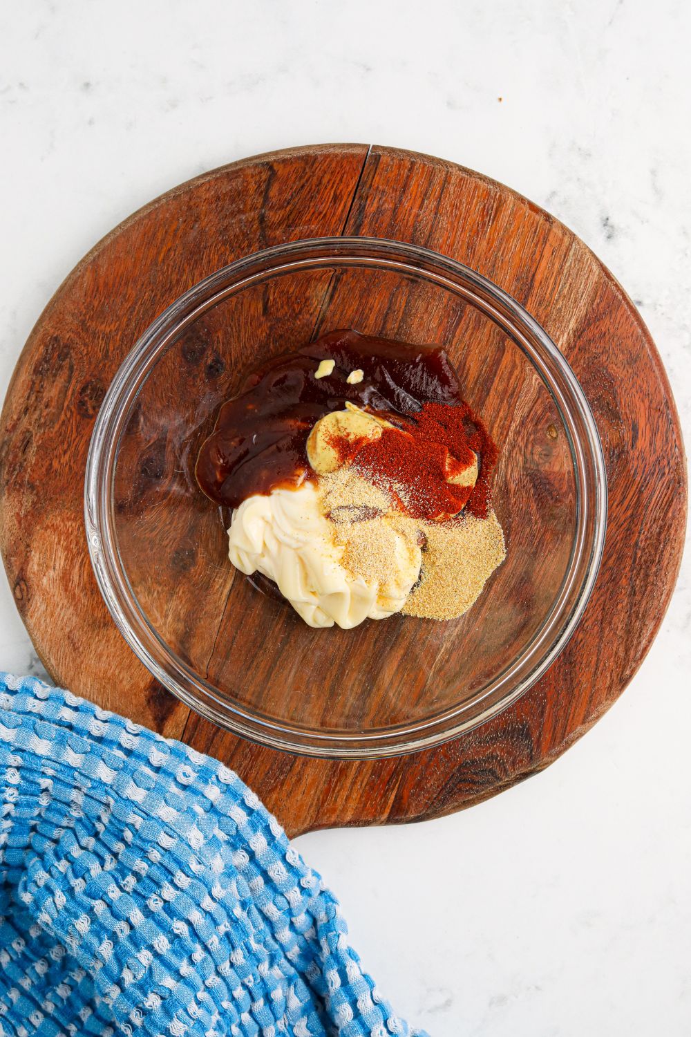 ingredients for Cowboy Burger sauce in a glass bowl on table 