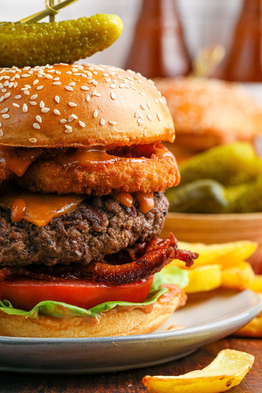 side view of a Cowboy Burger on a plate to see all the layers in the burger 