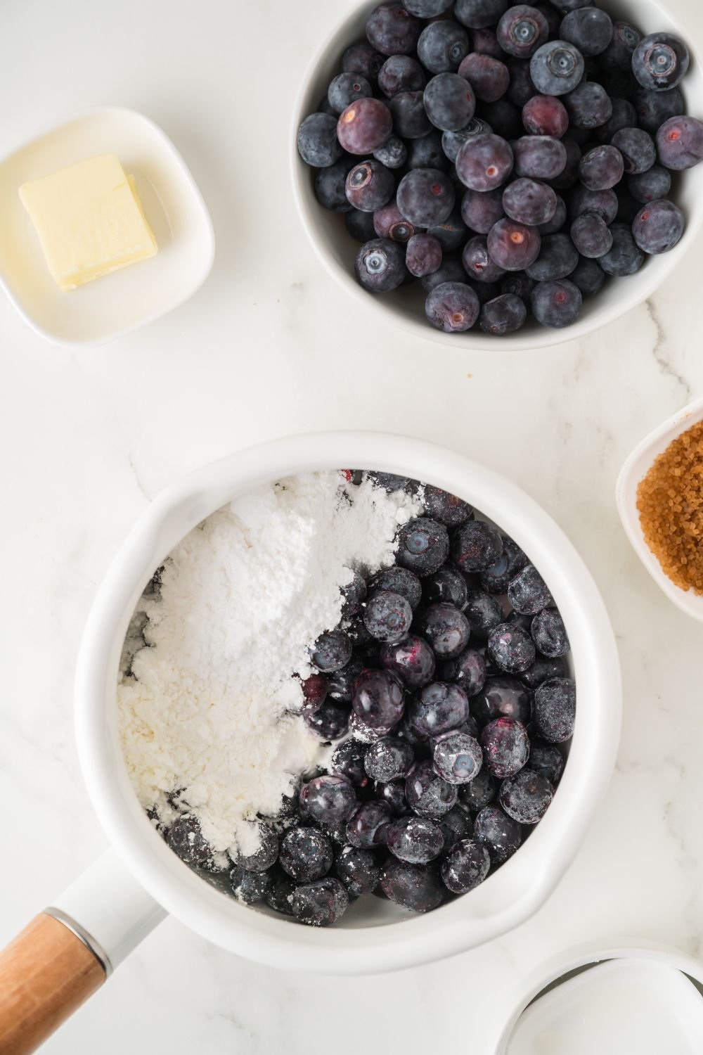 blueberry and sugar mixture in a bowl for making a blueberry sauce