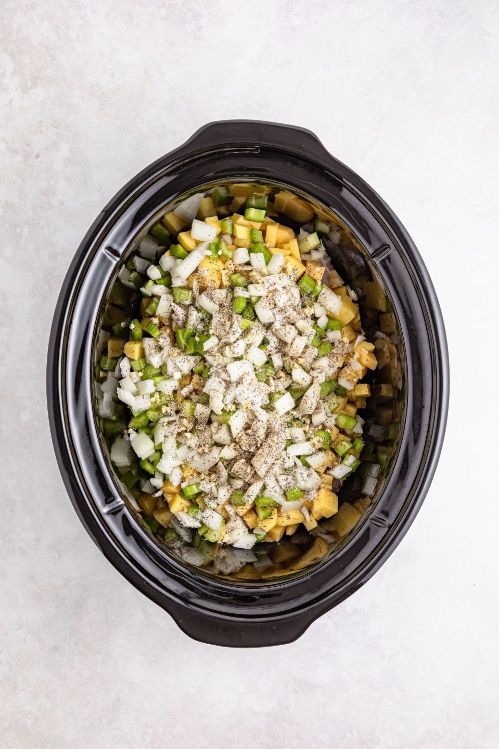 ingredients for pot pie in slow cooker on table 