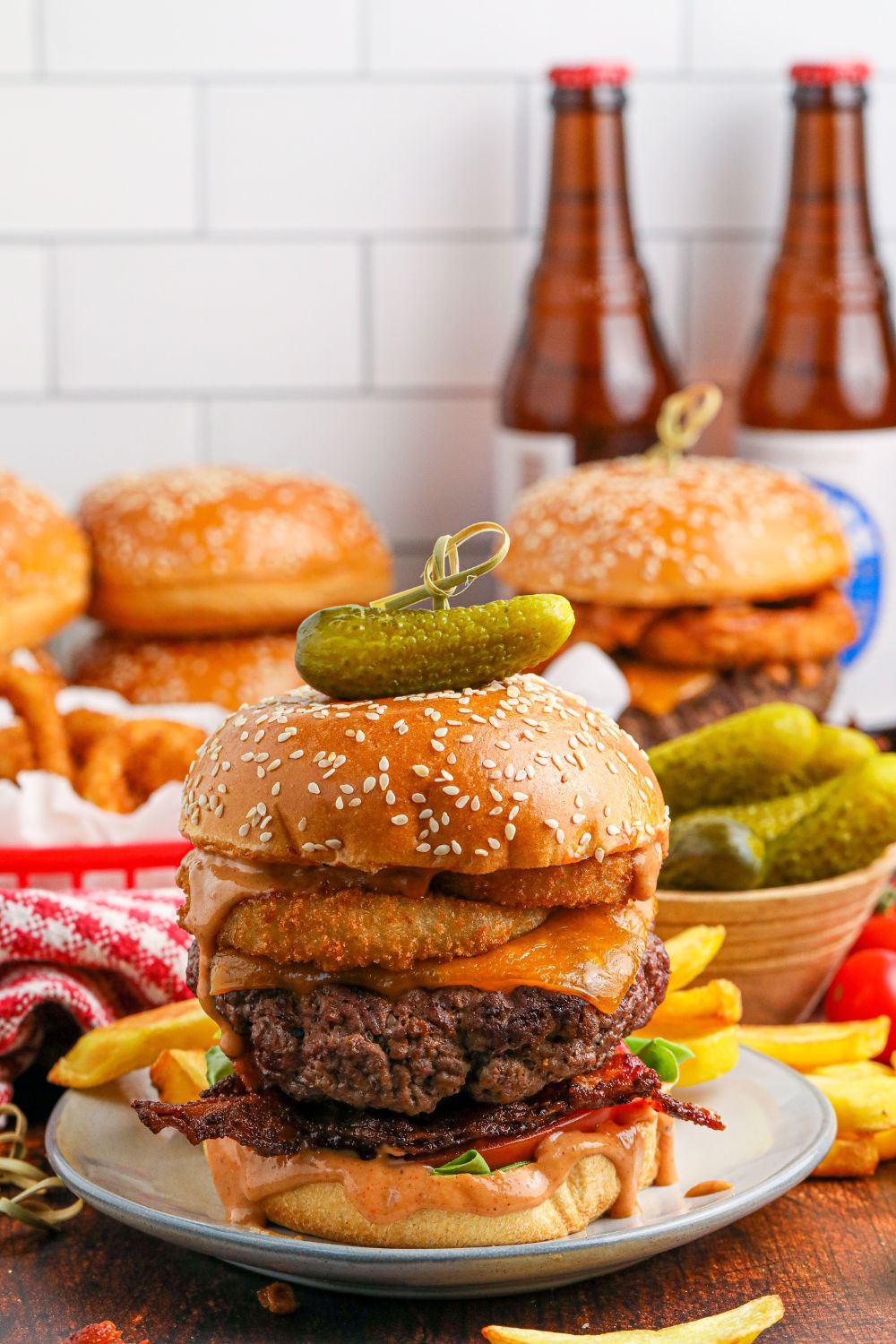 Cowboy burgers on table with beers in the background of image