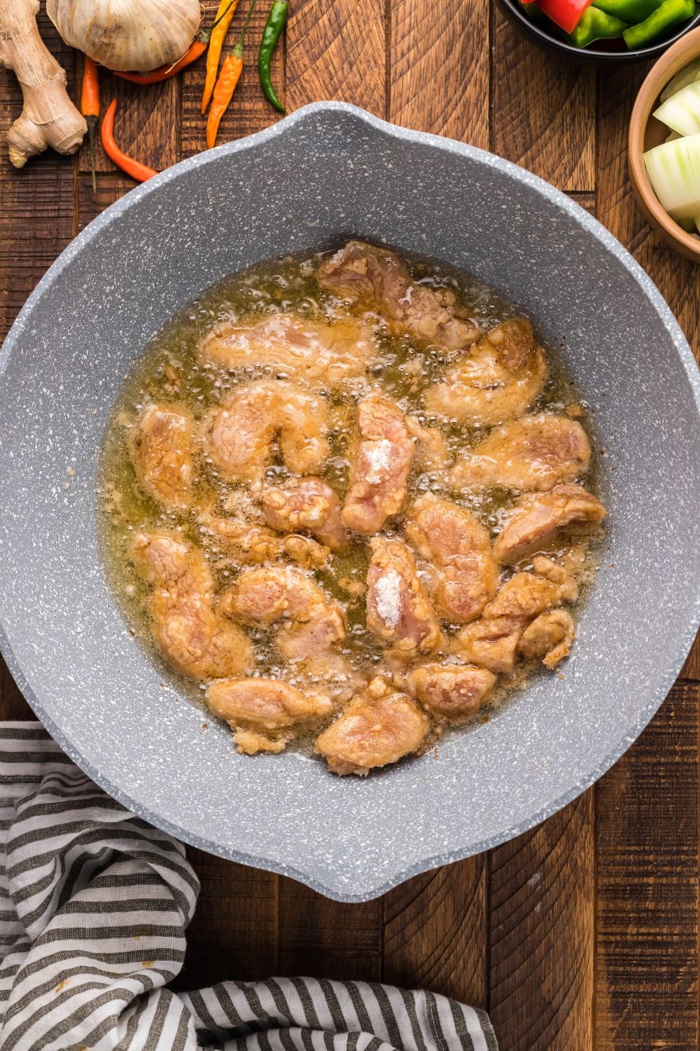 oil frying up diced chicken bites 