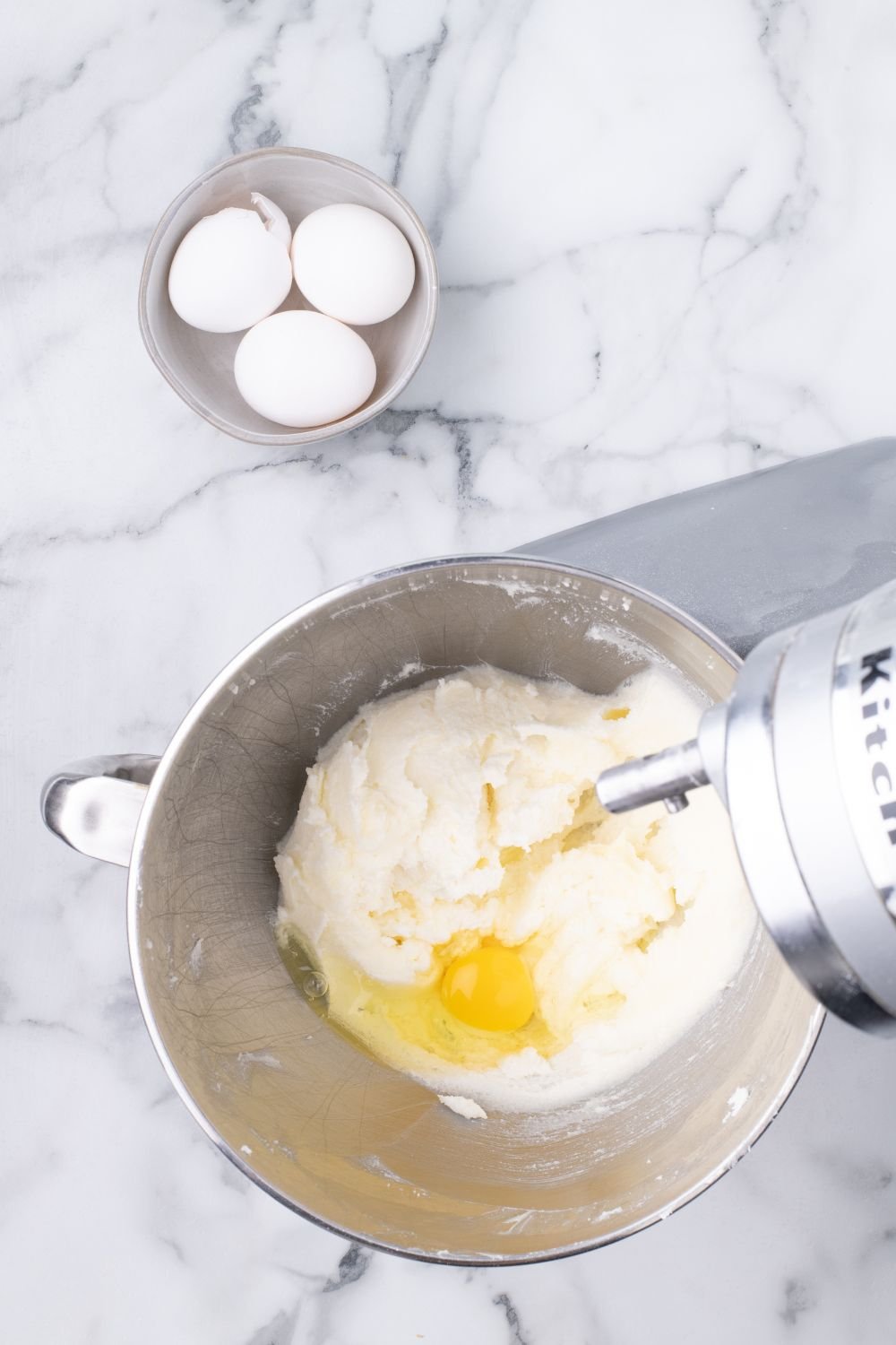 stand mixer with eggs and cake batter in it
