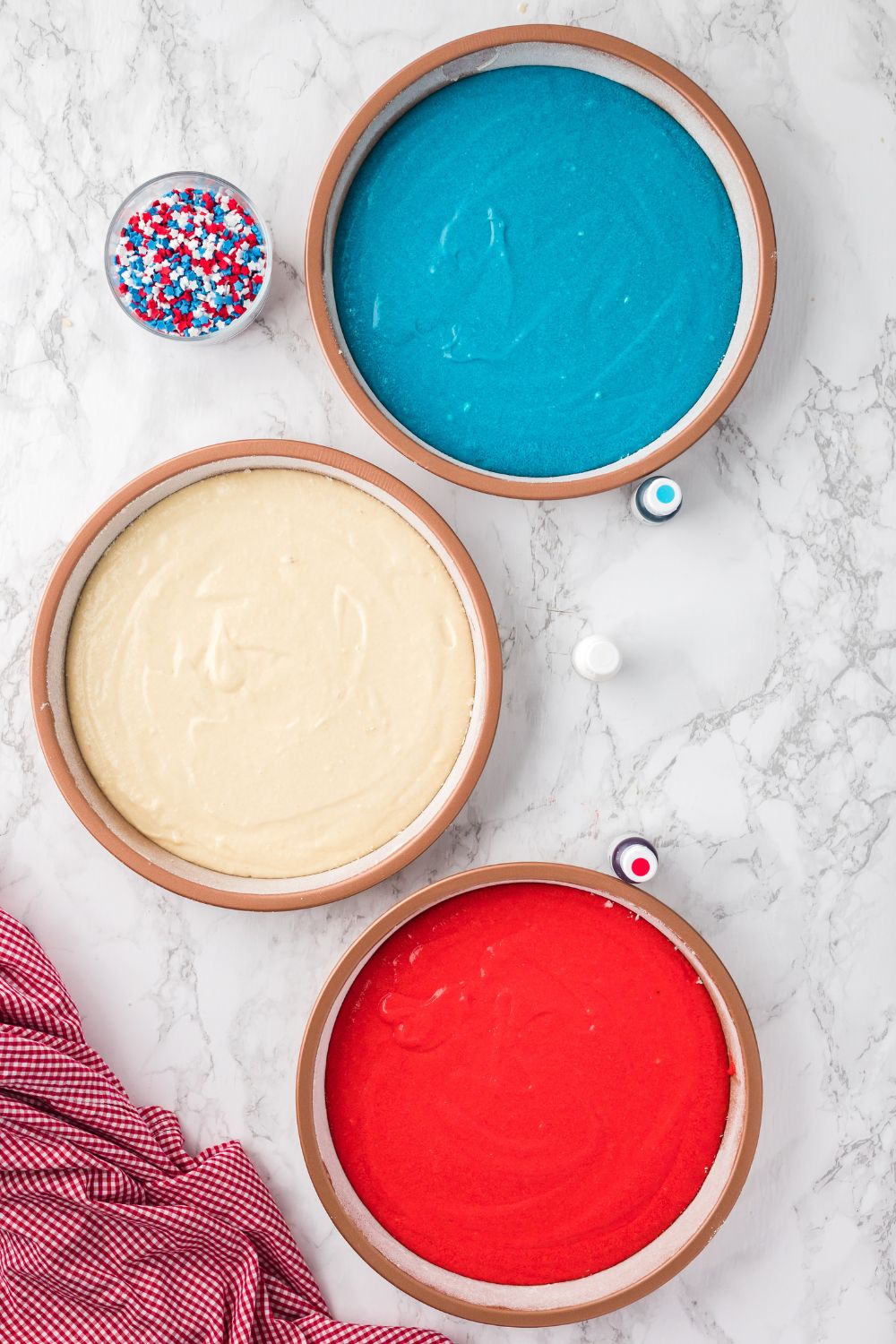 cake batter in round cake pans sitting on table 