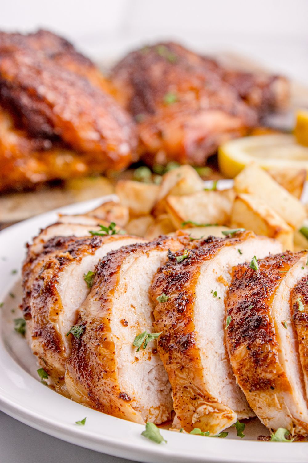 Smoked Whole Chicken on plate with some pieces sliced on it 