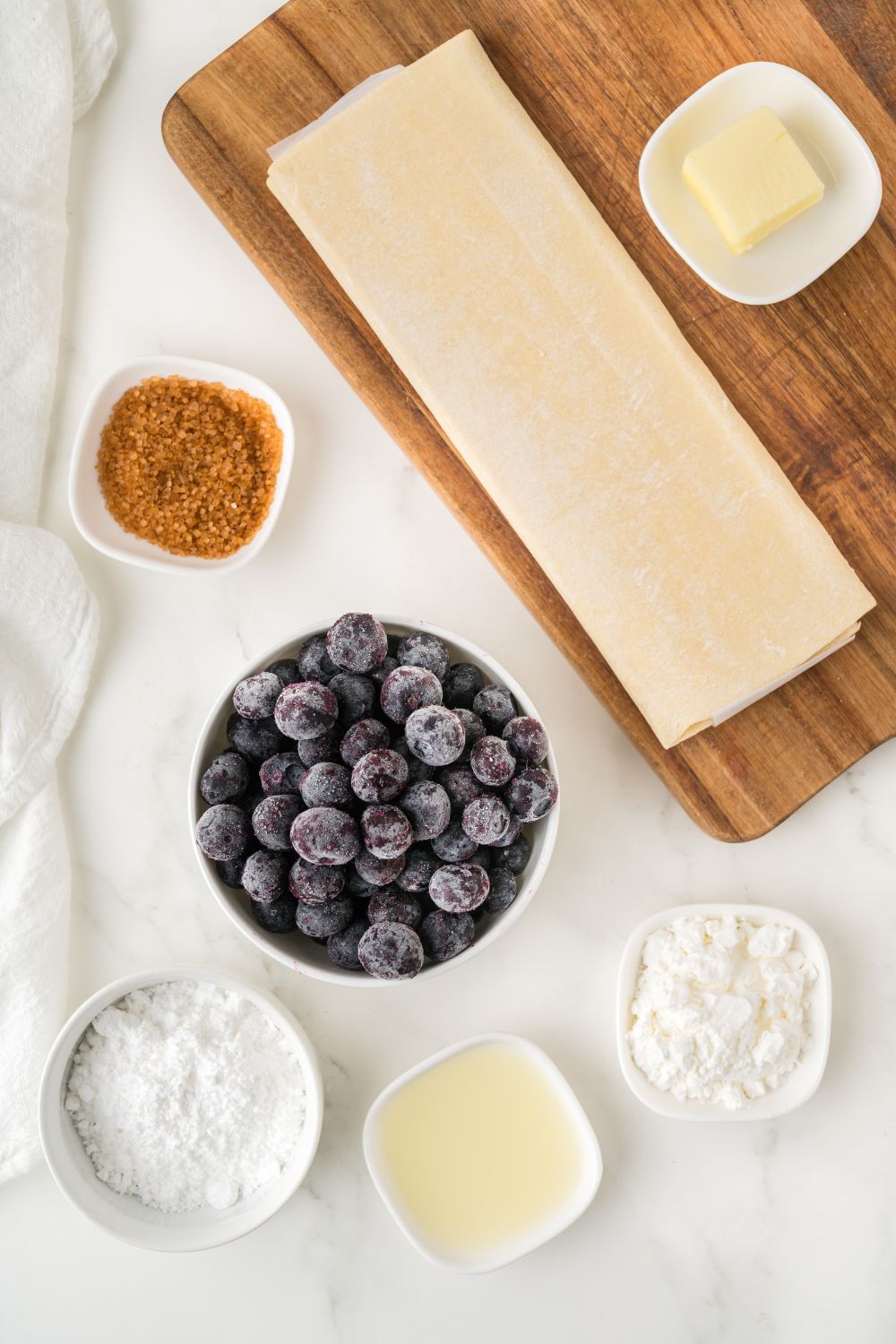 ingredients for Blueberry Turnovers in single serve containers sitting on table to show all the items 