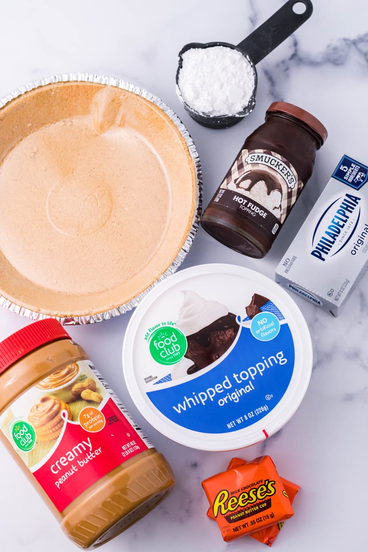 An overhead shot of all ingredients needed to make a no bake peanut butter cup pie.