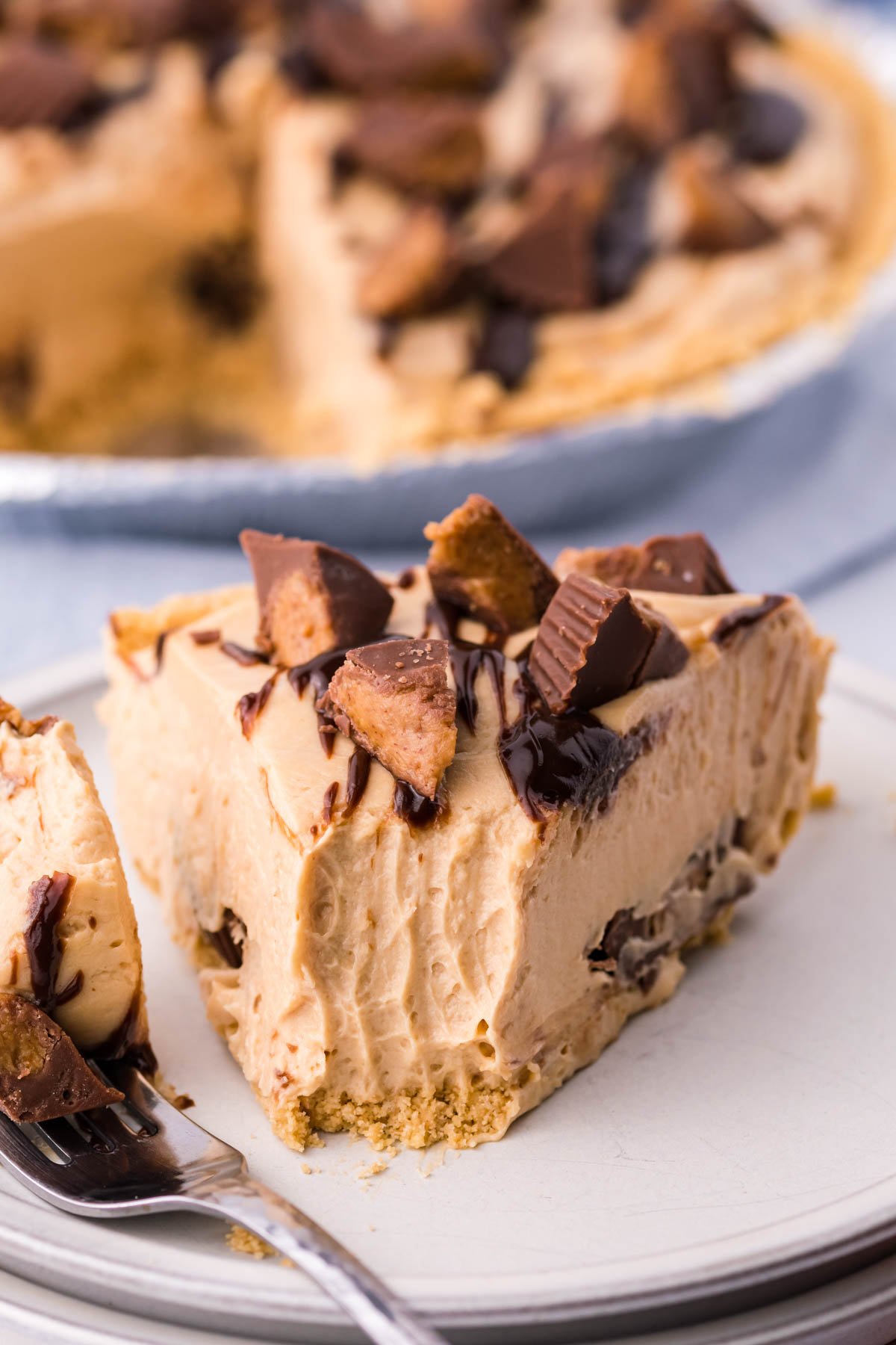 A close up shot of a bite being removed from a piece of no bake peanut butter cup pie. 
