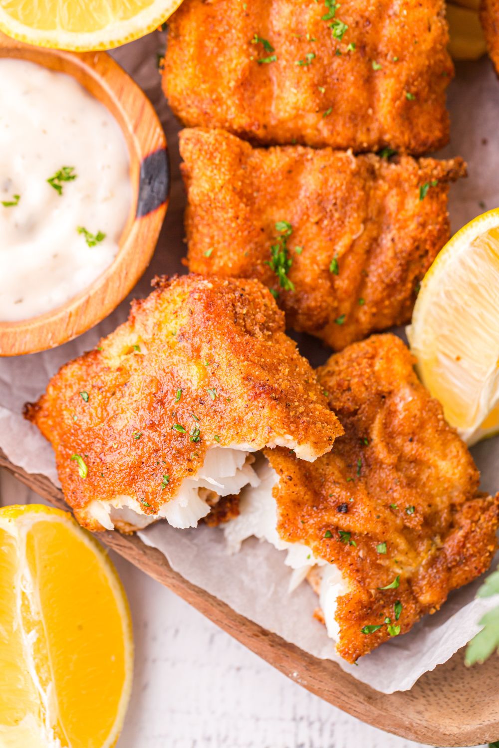 fish broke in half showing the flaky fish centers of the crispy fish fillets 