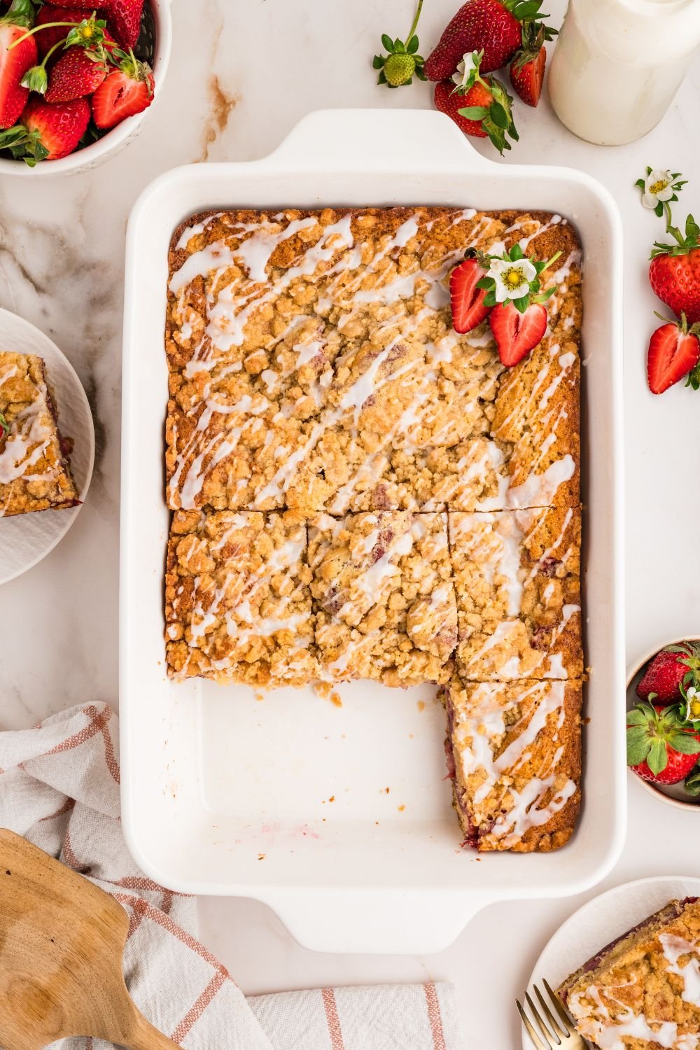 Strawberry Coffee Cake in pan with some slices cut out of it 
