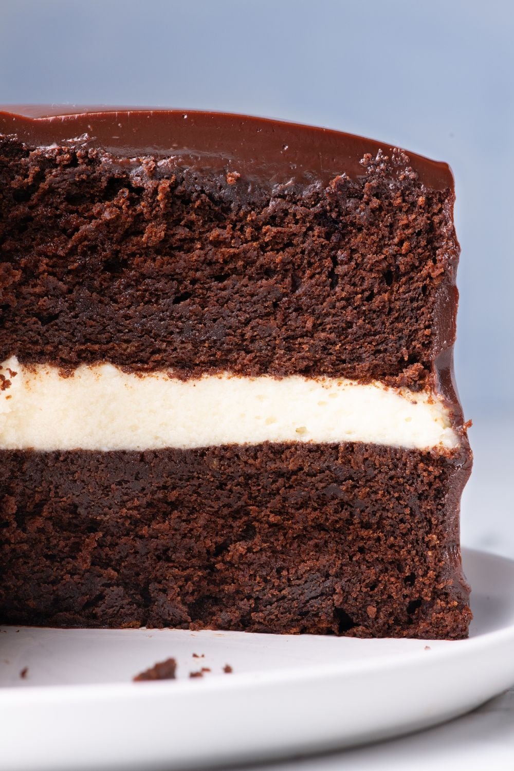 Ding Dong Cake with a slice taken out sitting on a cake platter on table to showcase the layers of cake 