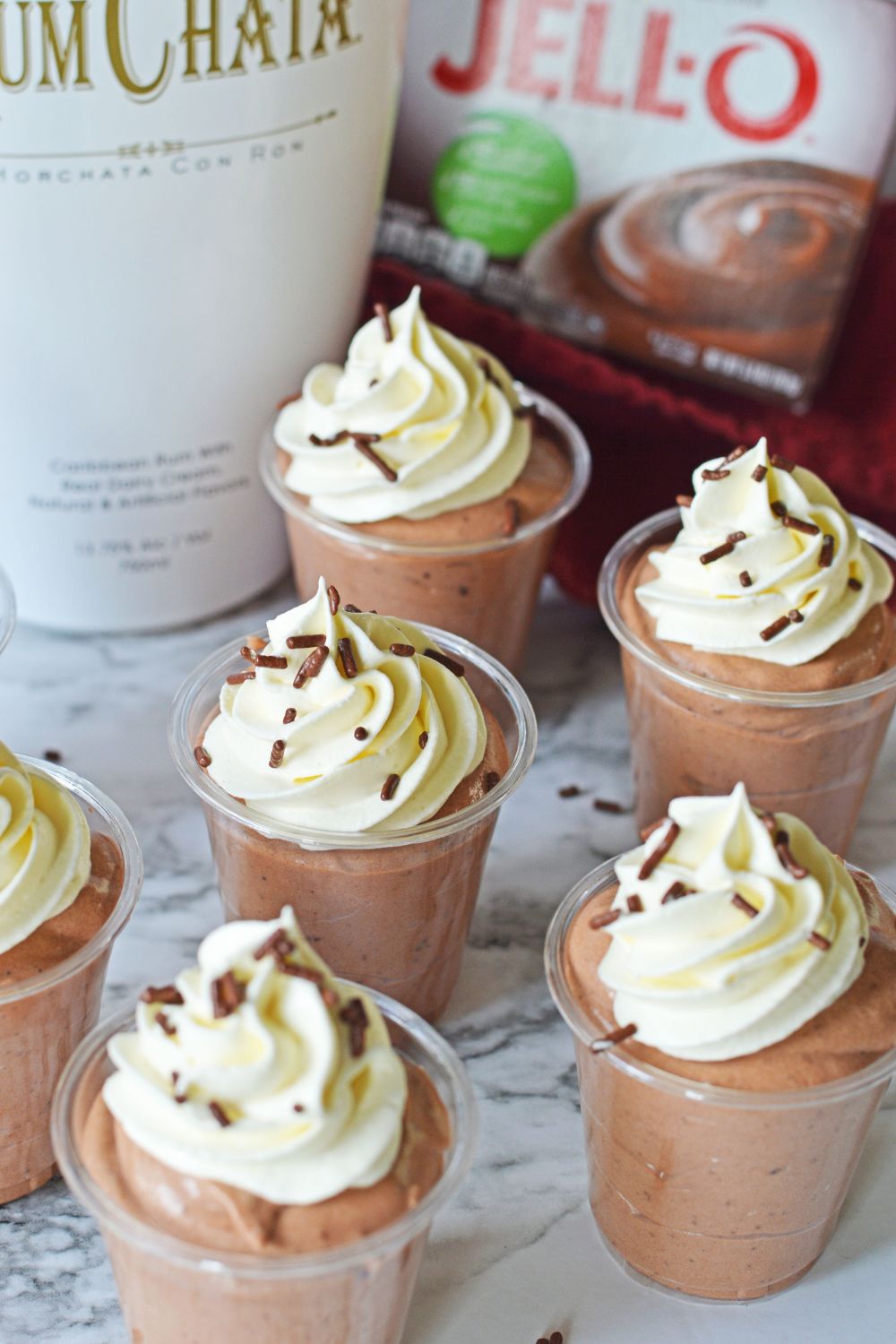 Rumchata Pudding Shots on table with shots spread out over the table 