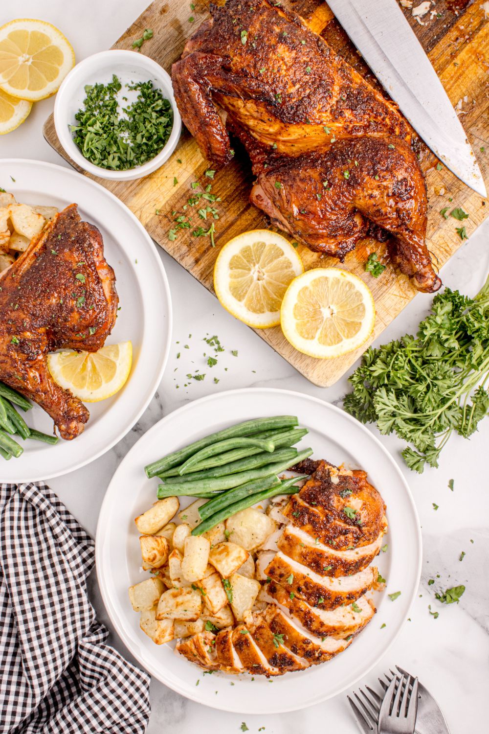 overhead look at dinner table with chicken on plate and side of chicken on cutting board