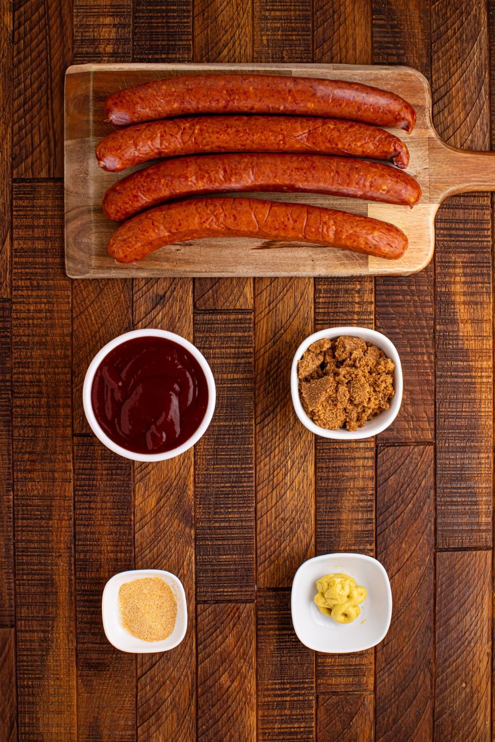ingredients for BBQ Hasselback Smoked Sausages on wooden table