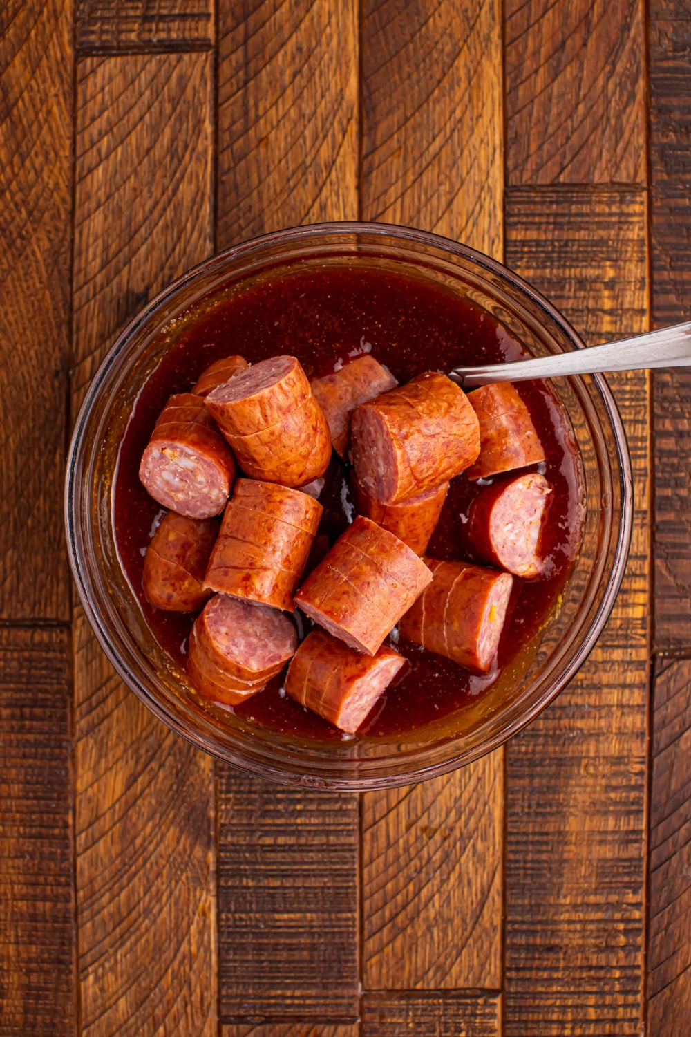 smoked sausage in a bowl with sauce 