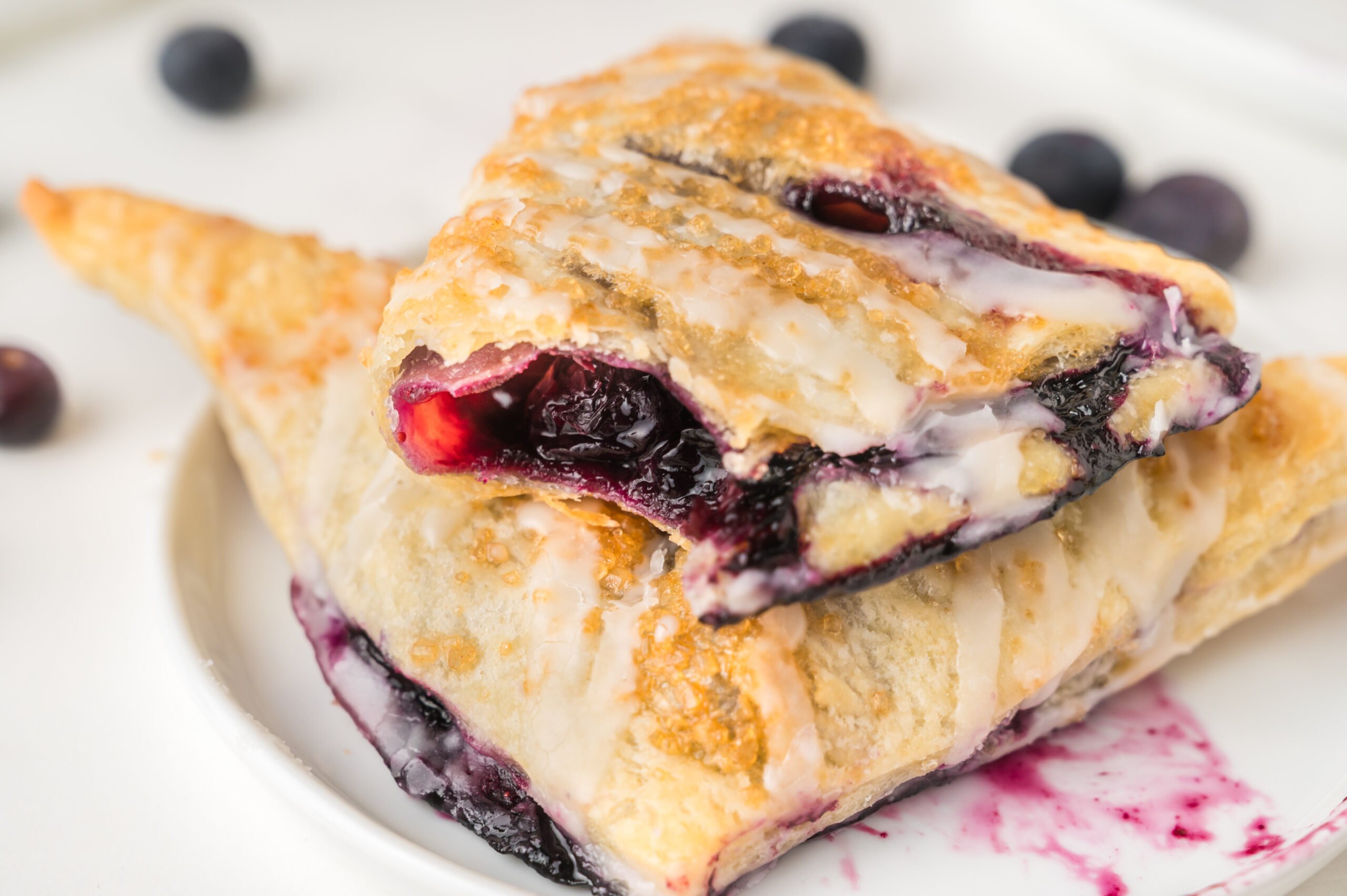 up close shot of  the Blueberry Turnovers on plate with a bite missing