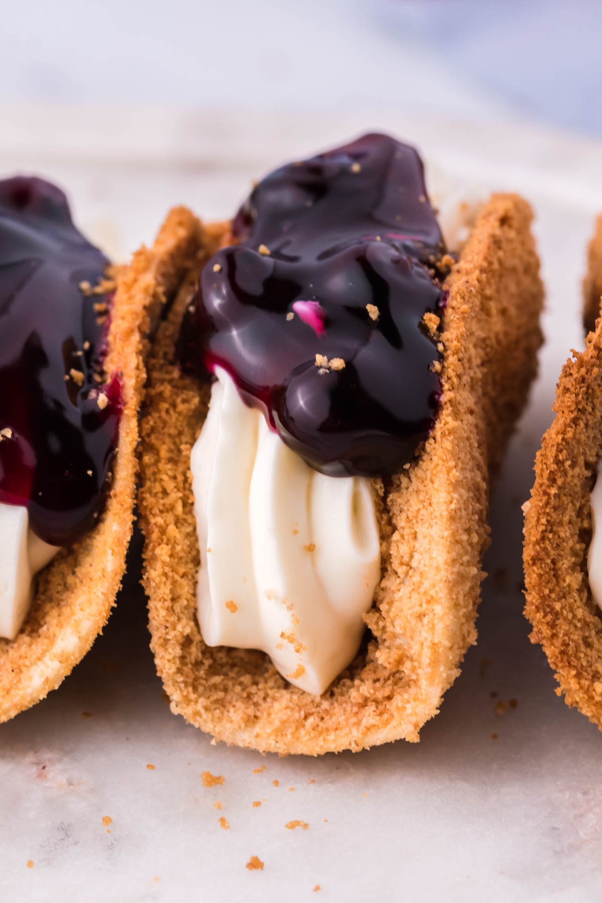 Close up of the filling and topping of blueberry cheesecake tacos. 