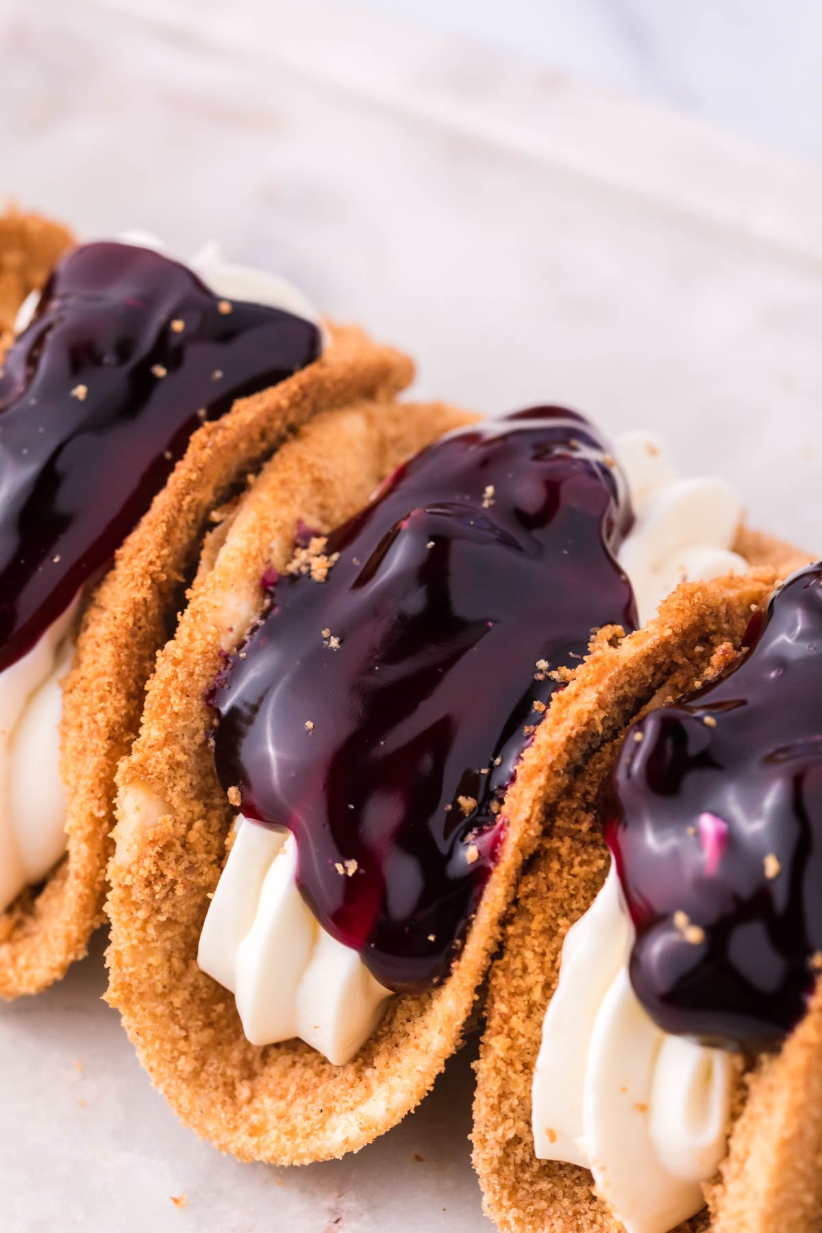 Close up of the filling and topping of blueberry cheesecake tacos. 